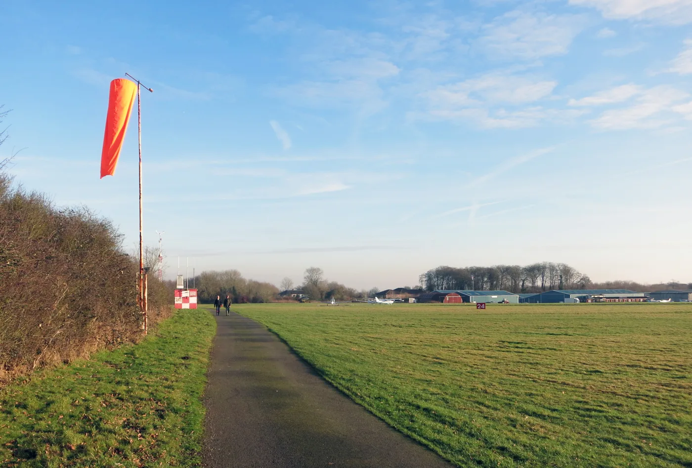 Wycombe Air Park at Booker, looking across the grass airfield towards the hangars. The 13 hectare data centre site is at the southern corner of the air park and is not shown in this view